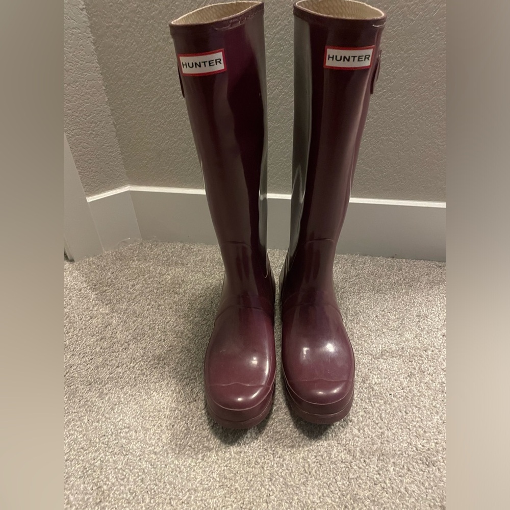 Tall purple hunter rain boots.